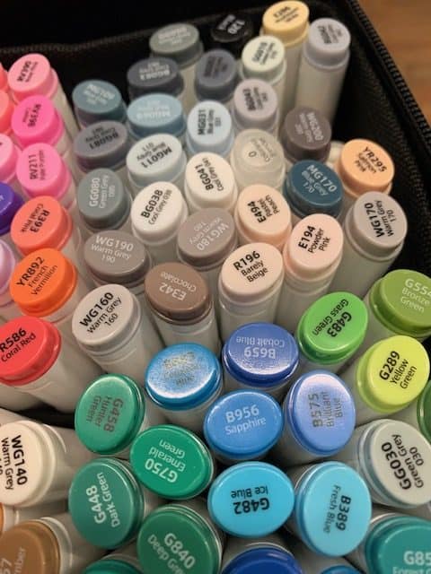 box full of Ohuhu markers in grays, blues, greens, and pinks