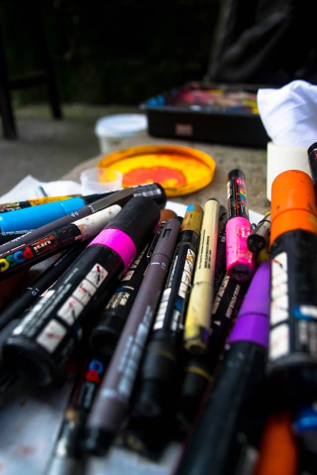 pile of colorful paint markers on the floor