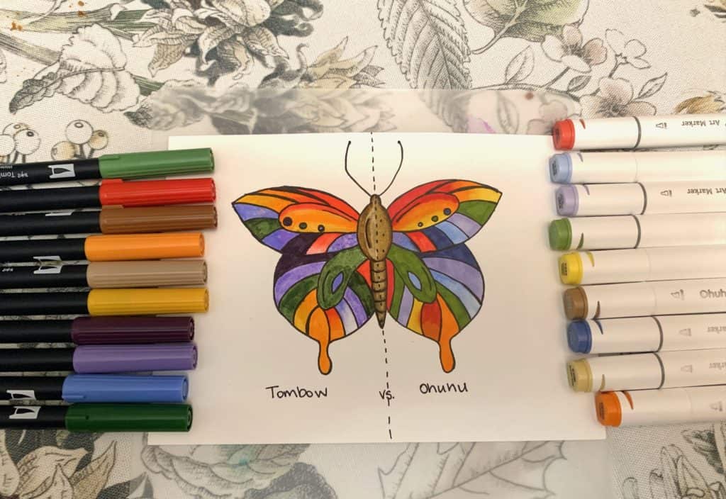 Marker drawn picture of a butterfly, surrounded by markers